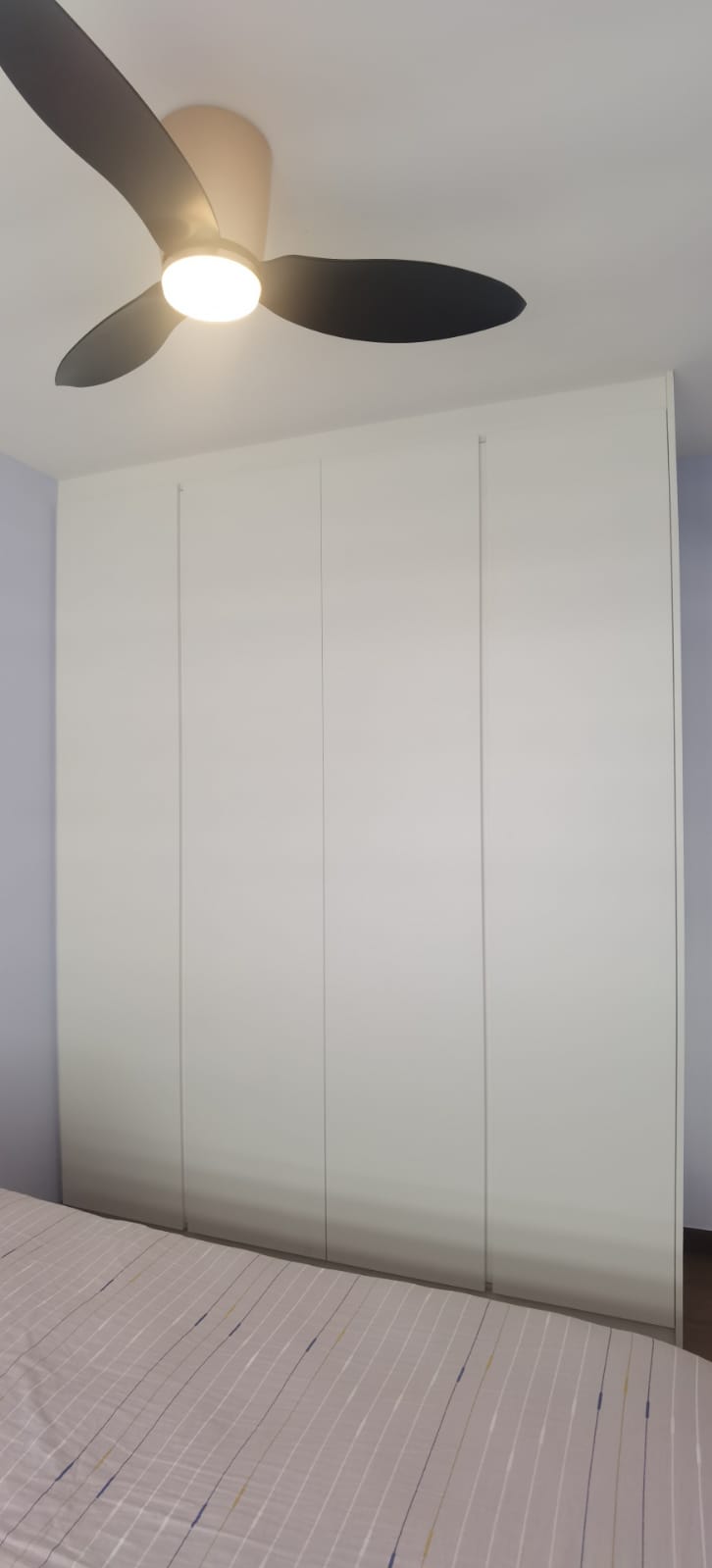 Built-in HDB wardrobe in bedroom with sliding doors